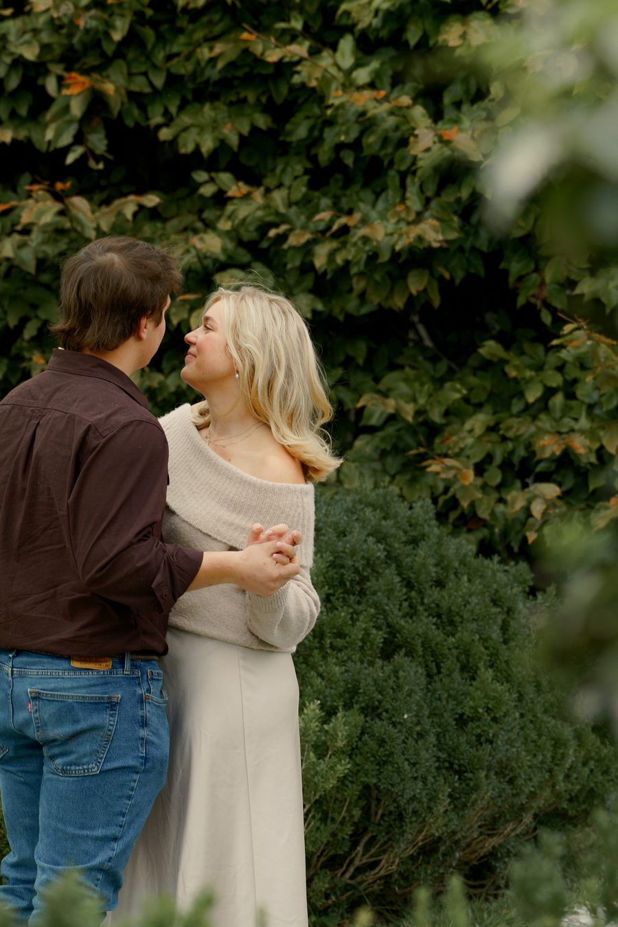 The couple standing together among the ivy
