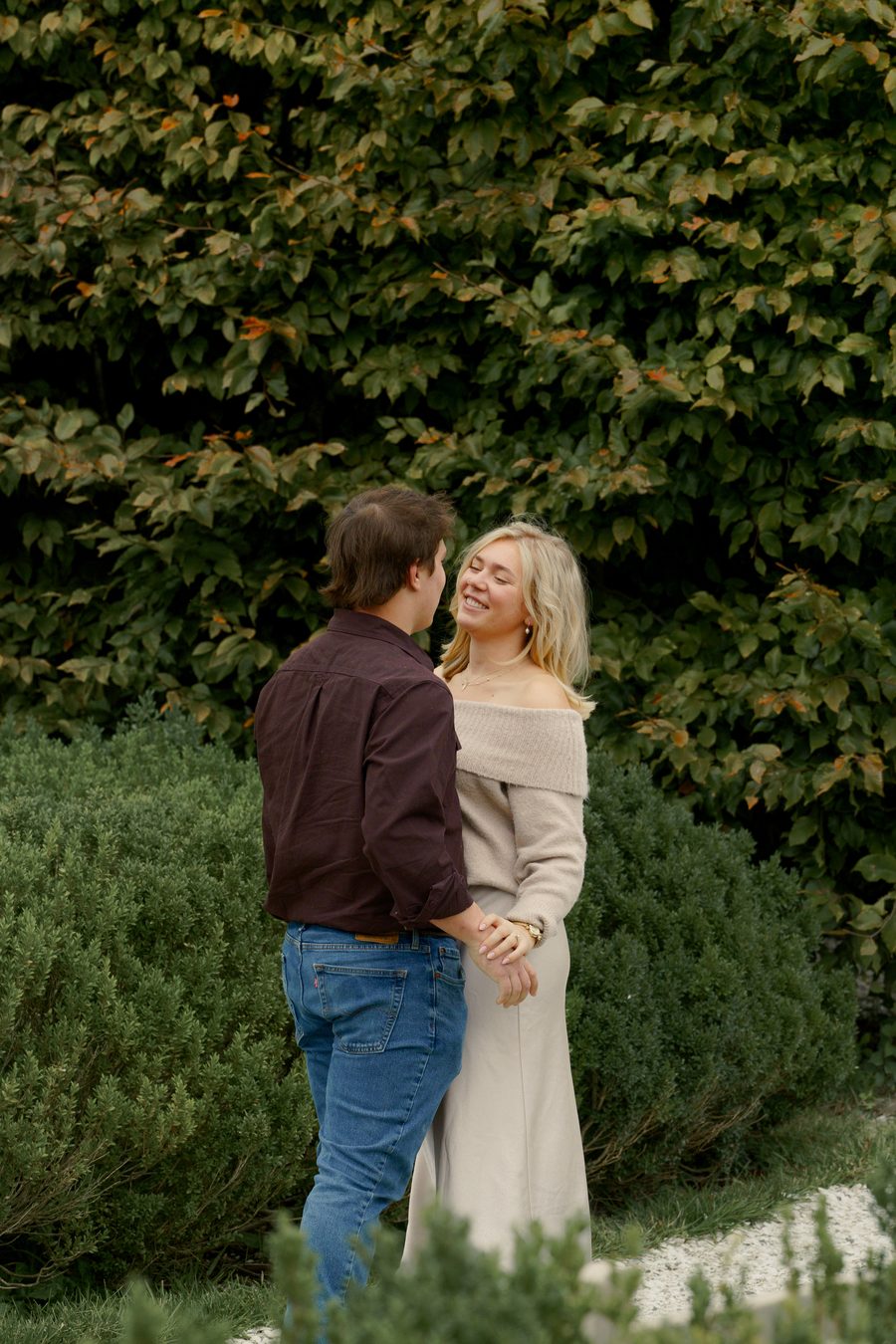 The couple facing each other in the garden