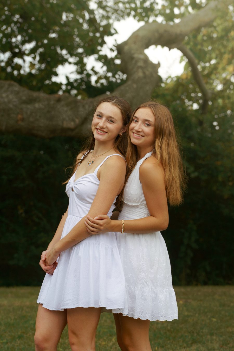 Two friends standing under a live oak