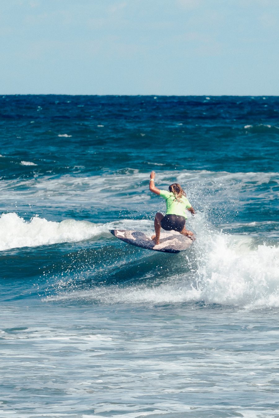 A surfer driving off the lip on a clean Virginia Beach wave