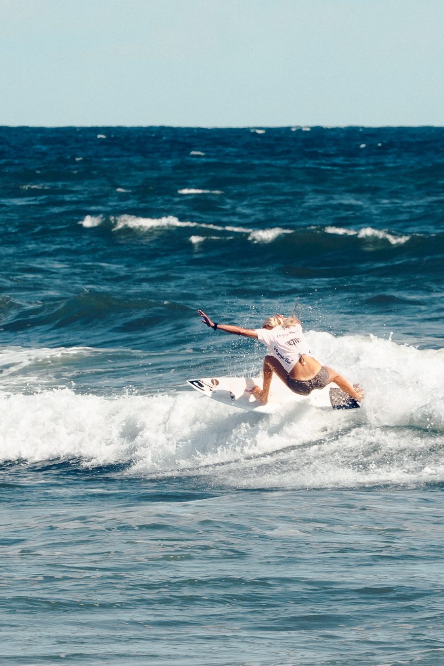 A competitor turning hard across the face of a wave